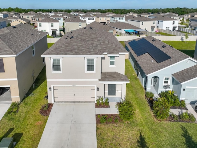 view of front of property with a garage and a front lawn