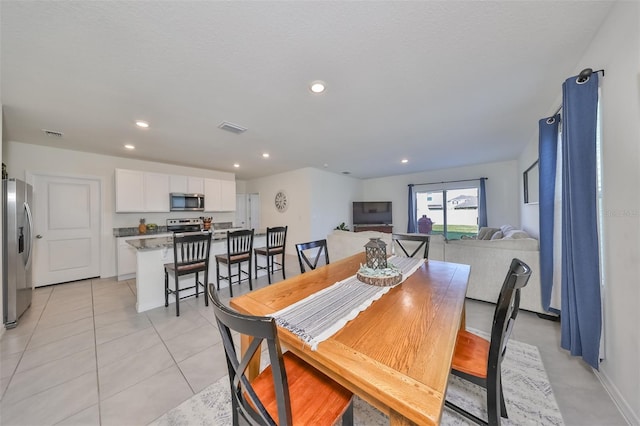 dining area featuring light tile patterned floors