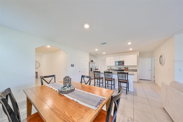 dining area featuring light tile patterned floors