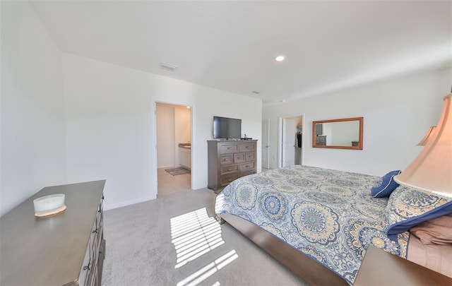 carpeted bedroom featuring connected bathroom