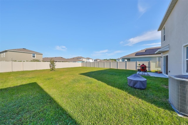 view of yard with central AC unit and a patio