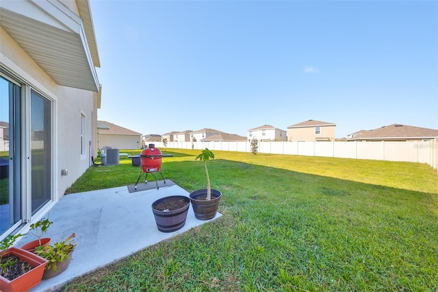 view of yard featuring central AC and a patio area