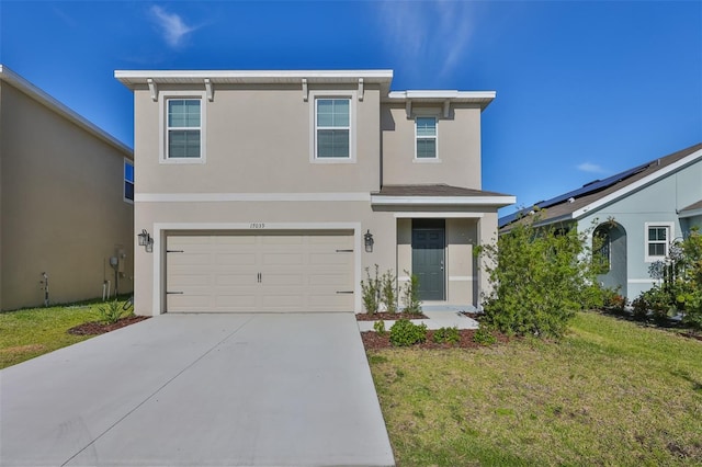 view of front of home featuring a garage and a front lawn