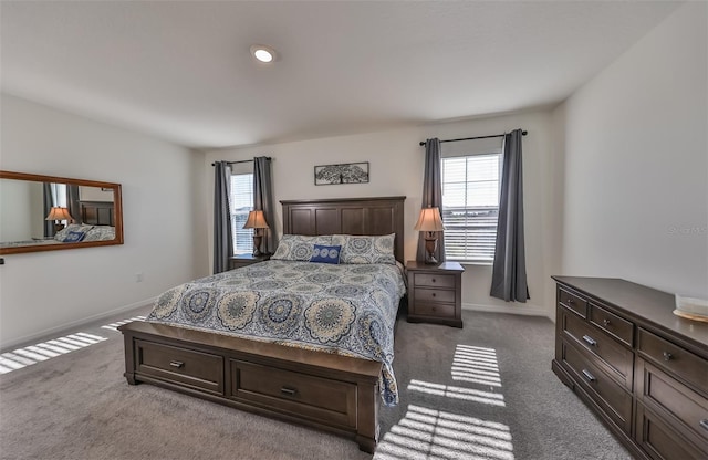 carpeted bedroom with multiple windows