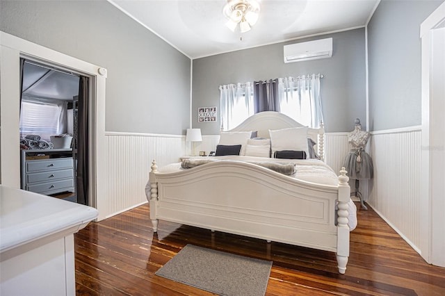 bedroom featuring dark hardwood / wood-style floors, ceiling fan, and a wall mounted AC