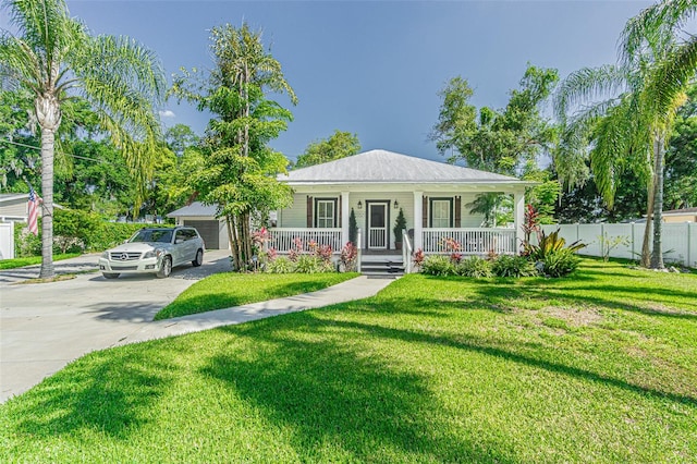 view of front of house with a garage, a front lawn, an outdoor structure, and a porch