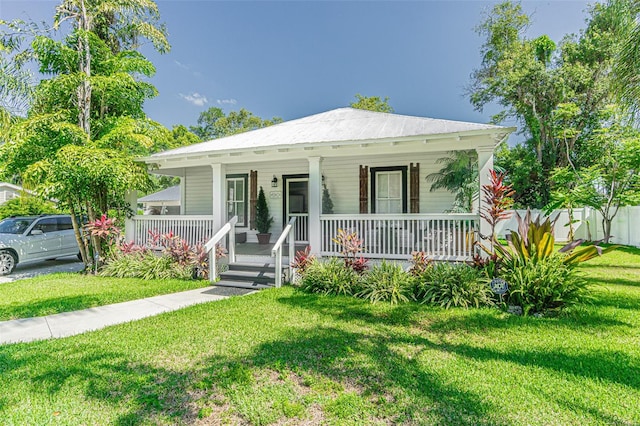 bungalow featuring a front lawn and covered porch