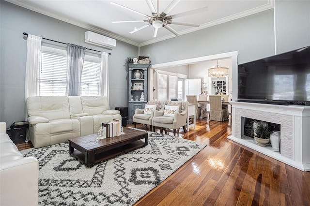 living room featuring a healthy amount of sunlight, dark hardwood / wood-style flooring, ornamental molding, and a wall mounted AC