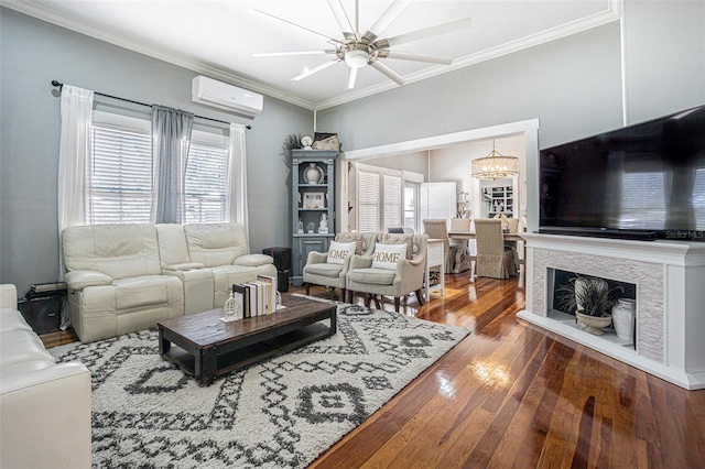 living room featuring a wall unit AC, plenty of natural light, dark hardwood / wood-style floors, and crown molding