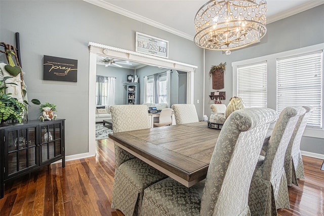 dining area with ceiling fan with notable chandelier, crown molding, and dark wood-type flooring