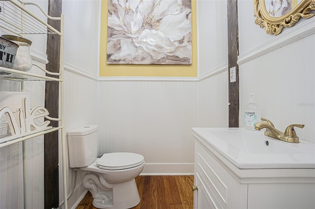 bathroom featuring wood-type flooring, toilet, and large vanity