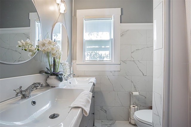 bathroom featuring tile walls, toilet, and vanity