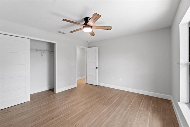 unfurnished bedroom featuring ceiling fan, light hardwood / wood-style floors, and a closet