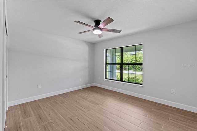 empty room featuring ceiling fan and light hardwood / wood-style floors