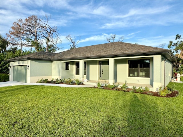 view of front of home with a garage, a front lawn, and covered porch