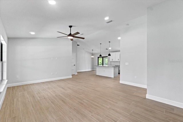 unfurnished living room featuring ceiling fan, light hardwood / wood-style flooring, and lofted ceiling