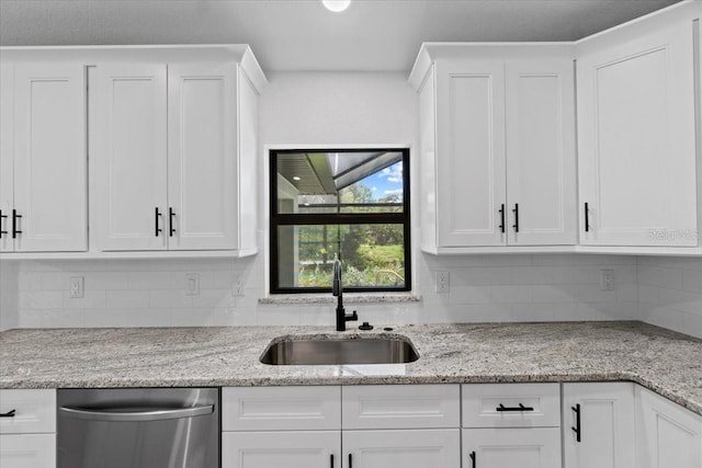 kitchen featuring white cabinets and sink