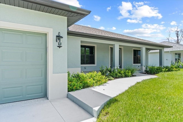 entrance to property featuring a lawn and covered porch