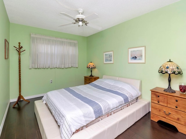 bedroom with ceiling fan and dark hardwood / wood-style flooring