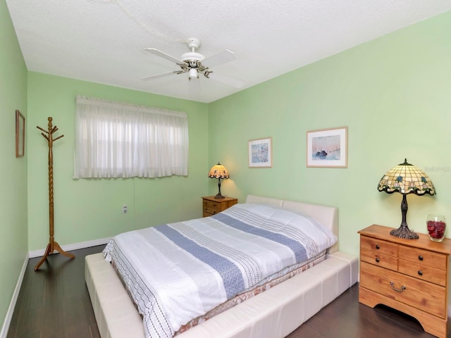 bedroom with ceiling fan and dark hardwood / wood-style floors