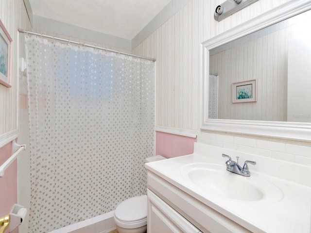 bathroom featuring vanity with extensive cabinet space and toilet