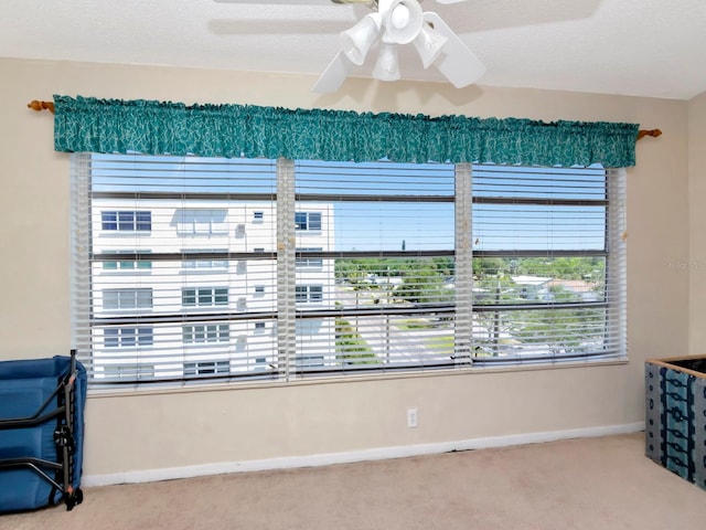 interior space with ceiling fan