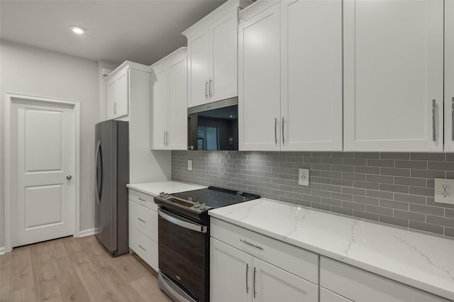 kitchen featuring light stone counters, light wood-type flooring, appliances with stainless steel finishes, and white cabinets