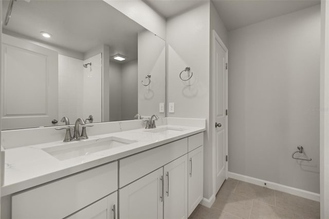 bathroom with tile patterned floors, walk in shower, and vanity