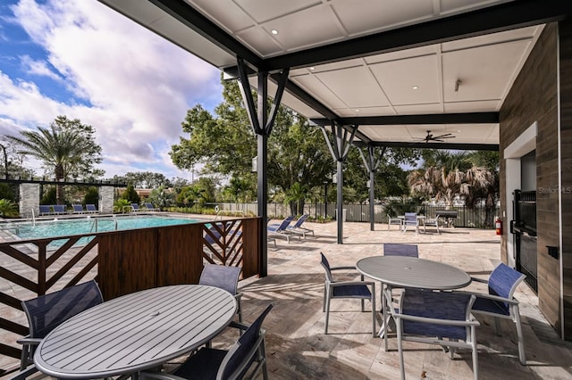 view of patio featuring a community pool and ceiling fan