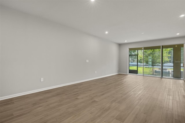 spare room with hardwood / wood-style floors