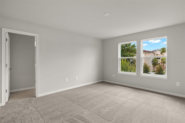 spare room featuring light colored carpet