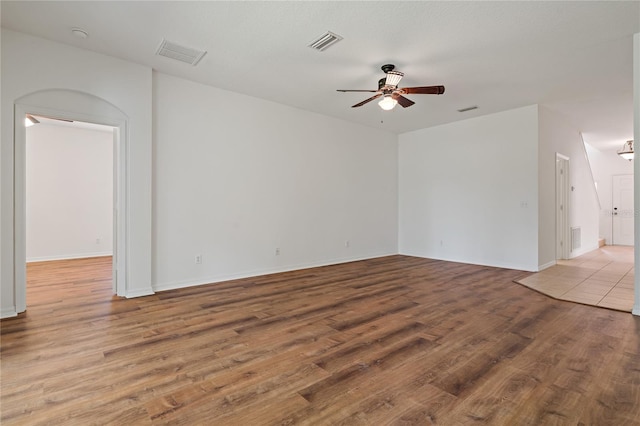 empty room with ceiling fan and light wood-type flooring