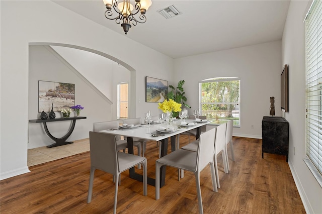 dining area with a notable chandelier and light hardwood / wood-style flooring