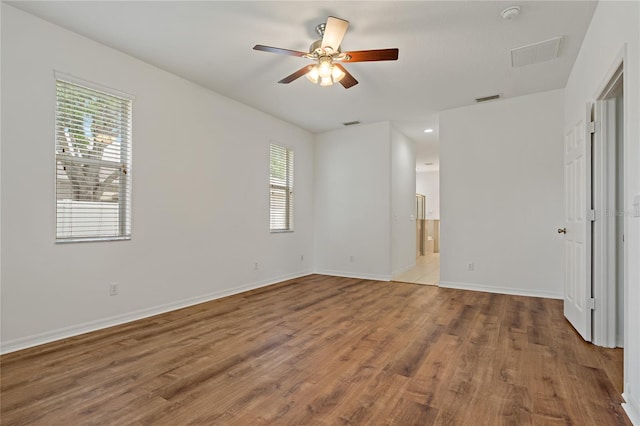 unfurnished room with hardwood / wood-style flooring and ceiling fan