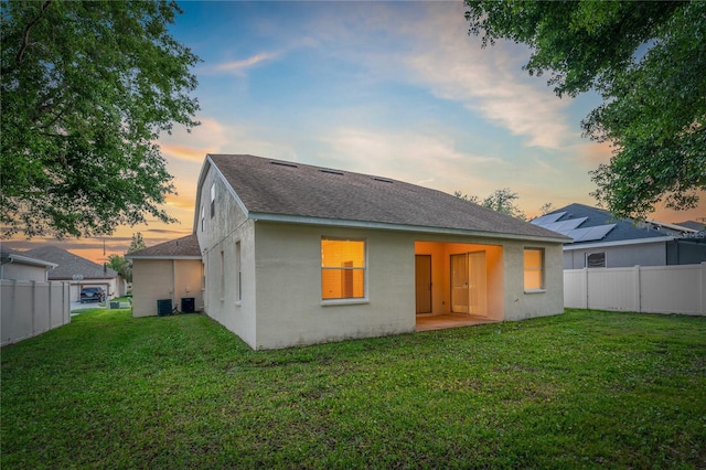 back house at dusk with a yard