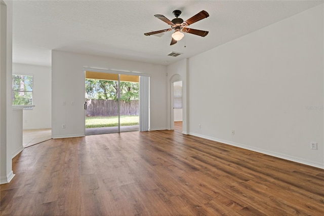 empty room featuring wood-type flooring, a textured ceiling, and ceiling fan