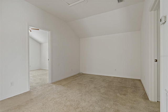 bonus room with light carpet and vaulted ceiling