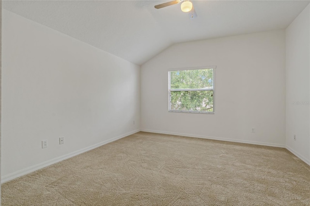 unfurnished room featuring ceiling fan, light colored carpet, and lofted ceiling