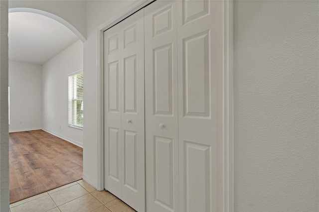 12814 Cattail Shore Ln, Riverview, FL 33579 - corridor with arched walkways and light tile patterned flooring