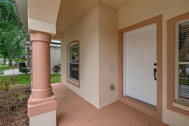 12814 Cattail Shore Ln, Riverview, FL 33579 - entrance to property with stucco siding and a porch