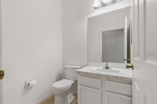 bathroom with vanity, tile patterned flooring, and toilet