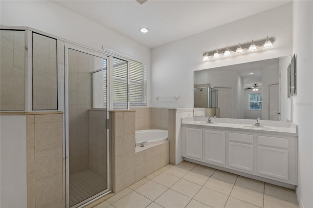 bathroom featuring independent shower and bath, a healthy amount of sunlight, and tile patterned floors