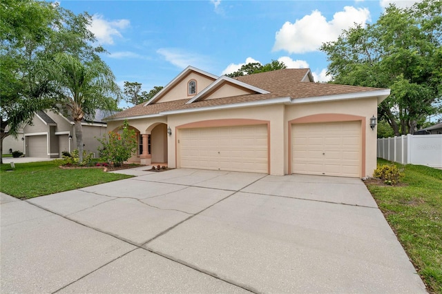 view of front facade featuring a garage and a front yard