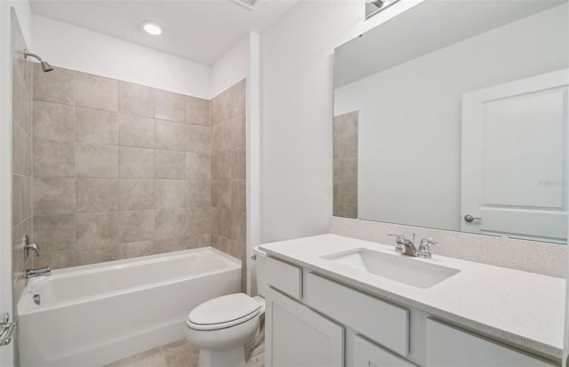 full bathroom featuring tiled shower / bath combo, toilet, and vanity