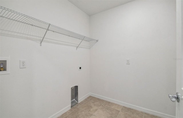 clothes washing area featuring electric dryer hookup, hookup for a washing machine, and light tile patterned floors