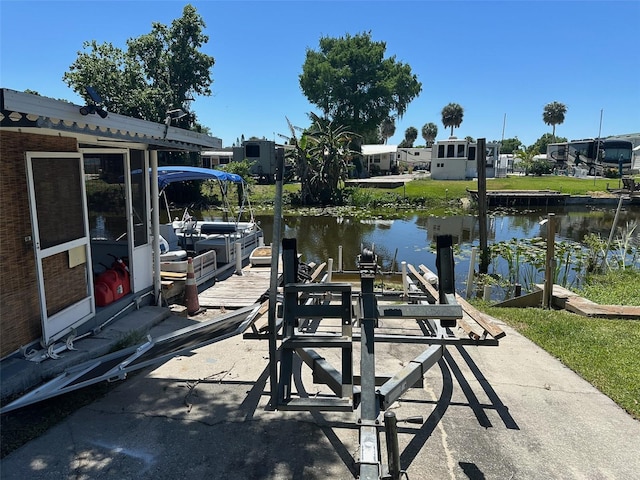 view of patio with a dock and a water view