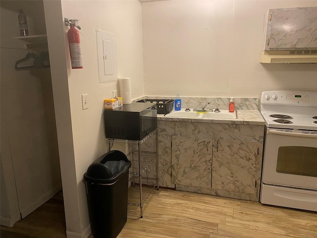 kitchen featuring light hardwood / wood-style flooring, sink, white electric range, and custom exhaust hood