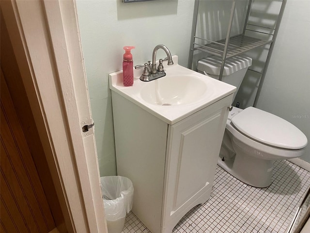 bathroom featuring vanity, toilet, and tile flooring