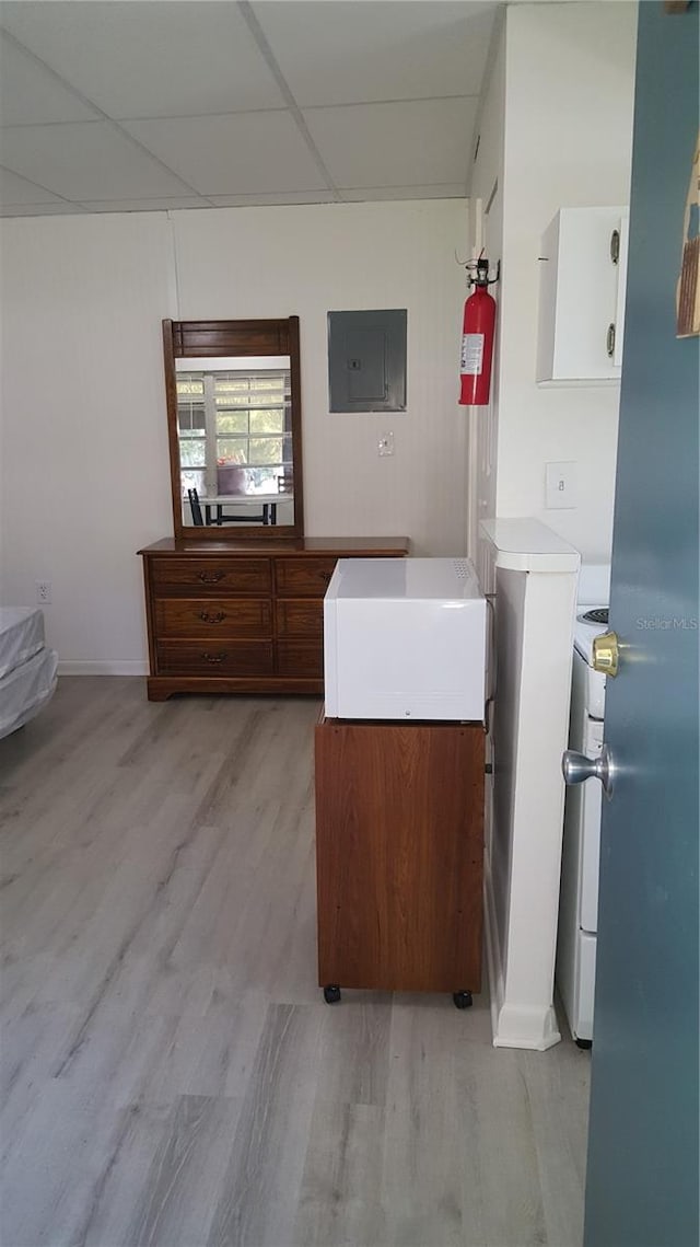 bathroom with wood-type flooring and a drop ceiling