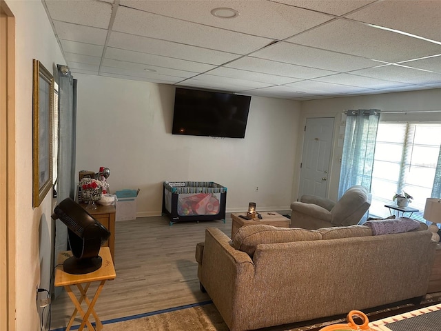 living room featuring a drop ceiling and wood-type flooring